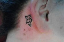 Tiny owl tattoo behind the ear