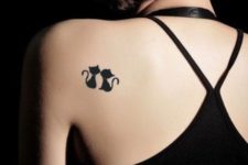Two cats tattoo