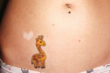 Yellow and brown little giraffe tattoo