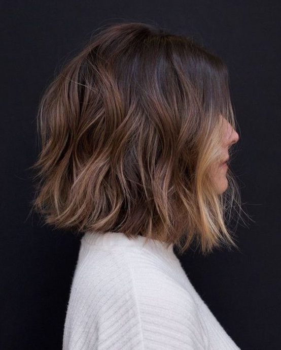 a dark brunette long bob with caramel highlights and a blonde money piece is a lovely and chic solution
