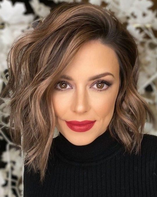a killer brown layered asymmetrical bob with chestnut balayage and waves looks amazing, it catches an eye