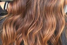 dark auburn hair with waves and lovely bold caramel balayage for a catchy and chic look just wows