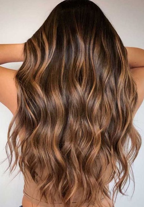long chestnut hair with waves and with caramel balayage is a great idea to bring dimension to long hair