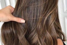 long dark brown hair with delicate honey and caramel babylights that help long strands look dimensional and bold
