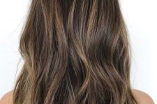 long dark wavy hair with a delicate caramel balayage is a lovely idea that doesn’t require much maintenance