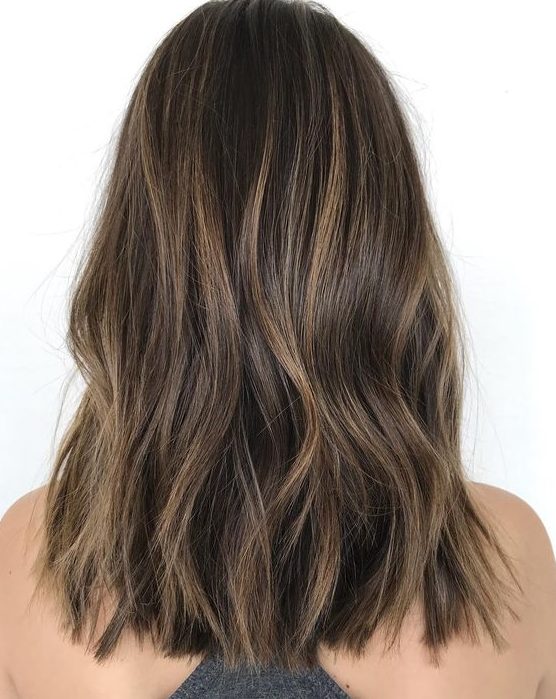 long dark wavy hair with a delicate caramel balayage is a lovely idea that doesn't require much maintenance