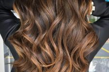 long dark wavy hair with lovely caramel highlights that give texture and dimension to the hairstyle and make it amazing