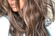 long deep brown hair with slight beachy highlights and babylights and waves looks very cute and very relaxed for summer