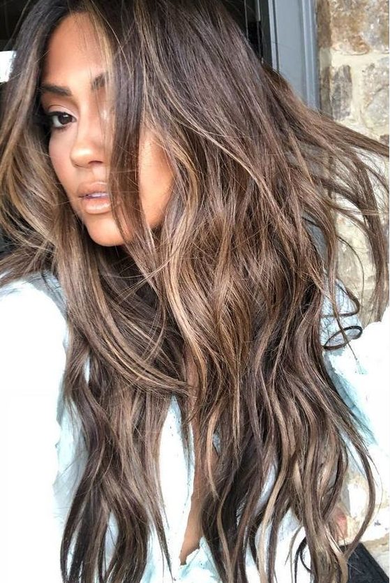 long deep brown hair with slight beachy highlights and babylights and waves looks very cute and very relaxed for summer