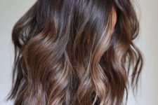 medium-length dark brunette hair with caramel balayage and waves is a lovely idea, and highlights bring dimension
