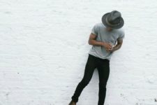 02 black jeans, a grey tee, brown boots and a hat
