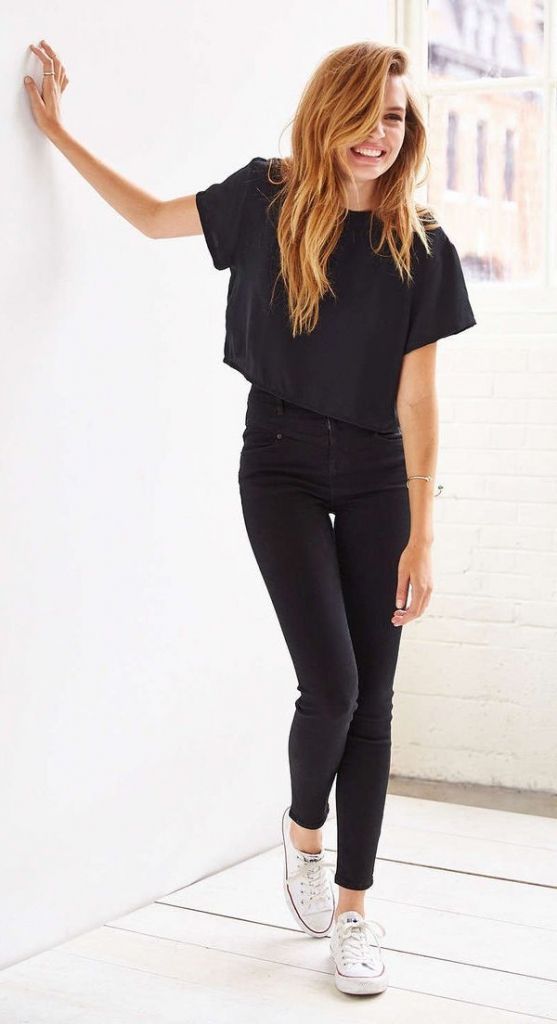 a black cropped tee, black jeans and white Converse