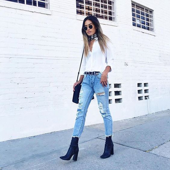 ripped distressed denim, a white shirt and navy boots