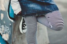 10 black converse, black and white striped leggings, a denim skirt and a grey sweatshirt