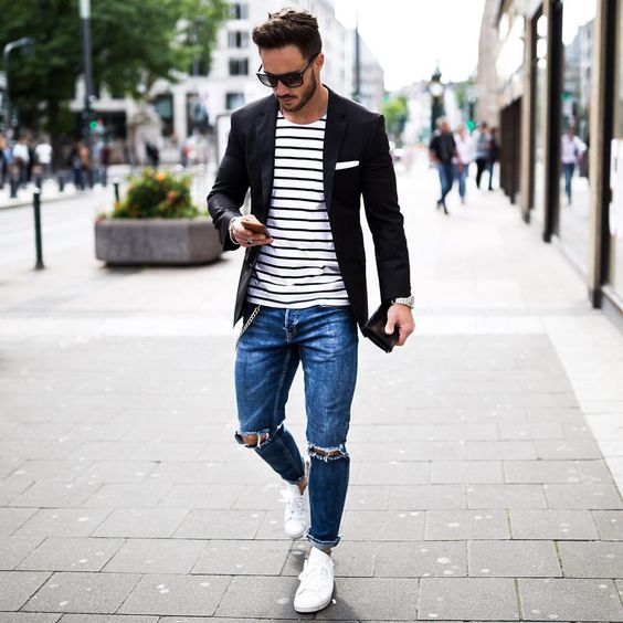 blue ripped jeans, a striped tee, a black jacket and white sneakers