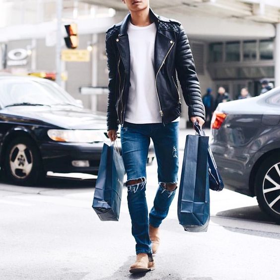 blue ripped jeans, a white tee, a black leather jacket and ocher boots