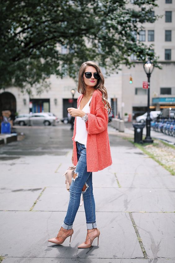 ripped blue skinnies, a white top, lace up blush shoes and a coral cardigan