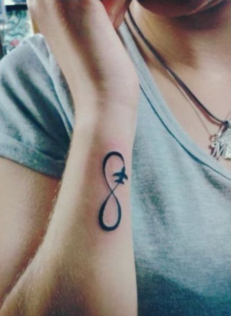 Airplane and infinity sign tattoo
