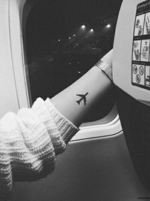 Black airplane tattoo