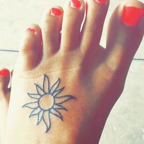 Black contour tattoo on the foot