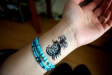 Blue horse tattoo on the wrist