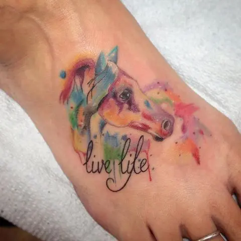 Colorful horse tattoo with phrase