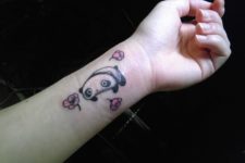 Panda bear with pink flowers tattoo