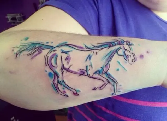 Purple and blue horse tattoo on the arm