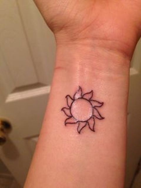 Sun tattoo on the wrist