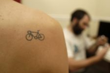 Tiny bicycle tattoo on the shoulder