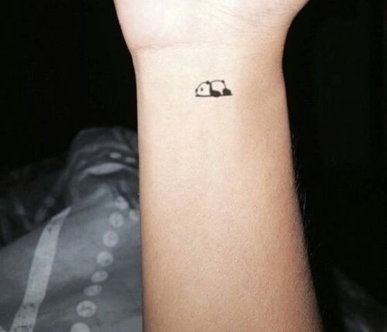 Tiny panda tattoo on the wrist
