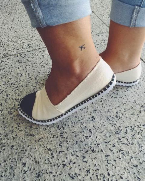 Tiny travel tattoo on the ankle