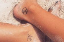 Travel tattoos on the ankles