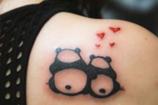 Two panda bears with red hearts tattoo