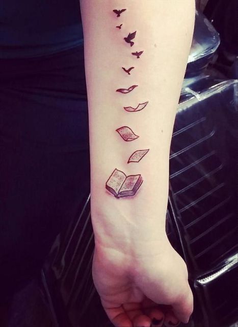 Unique book tattoo on the arm