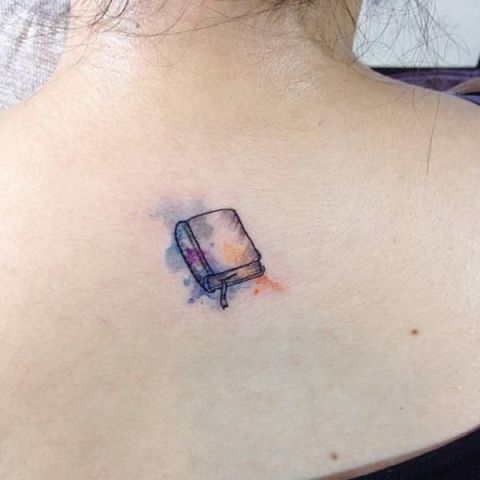 Watercolor book tattoo on the back