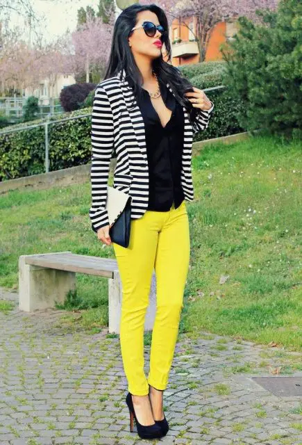 With black shirt, striped jacket, heels and black and white clutch
