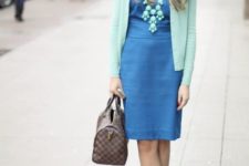 With blue dress and printed bag