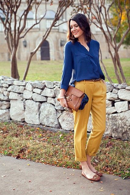 With blue shirt, brown flats and bag