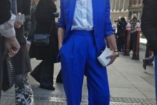 With classic button down shirt, cobalt blue jacket and mini clutch
