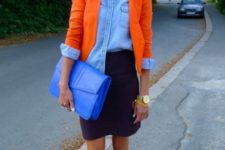 With denim shirt, mini skirt, orange heels and blue clutch