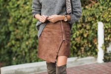 With gray turtleneck, over the knee boots and leopard clutch