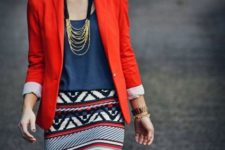 With navy blue shirt, printed skirt and necklace