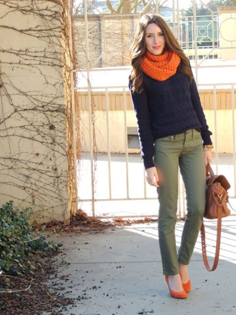 With orange scarf, sweater, olive green trousers and leather bag