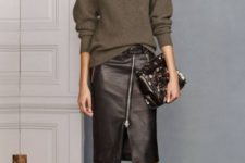 With oversized sweater, brown shoes and clutch