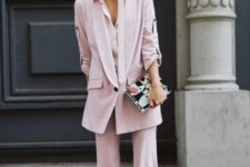 With pale pink long blazer and clutch