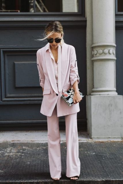With pale pink long blazer and clutch