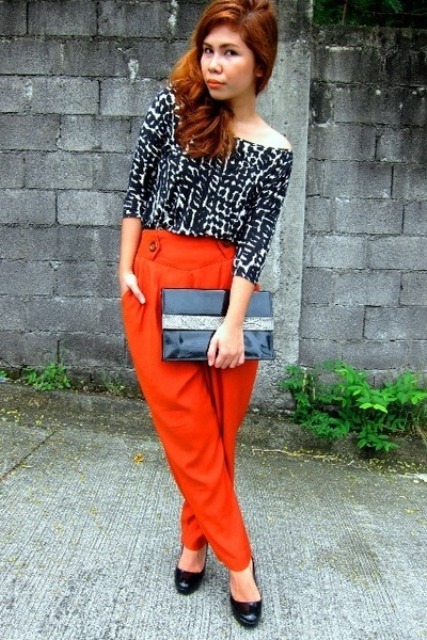 With printed blouse, black shoes and clutch