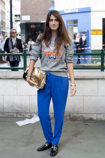 With printed sweatshirt, black loafers and metallic clutch