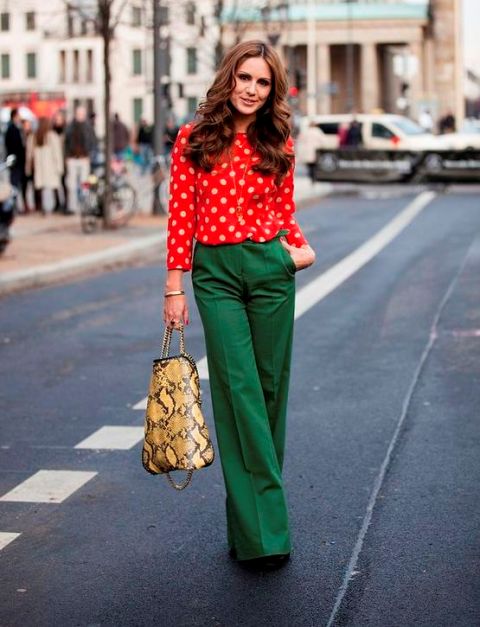 With red polka dot blouse, printed bag and black shoes